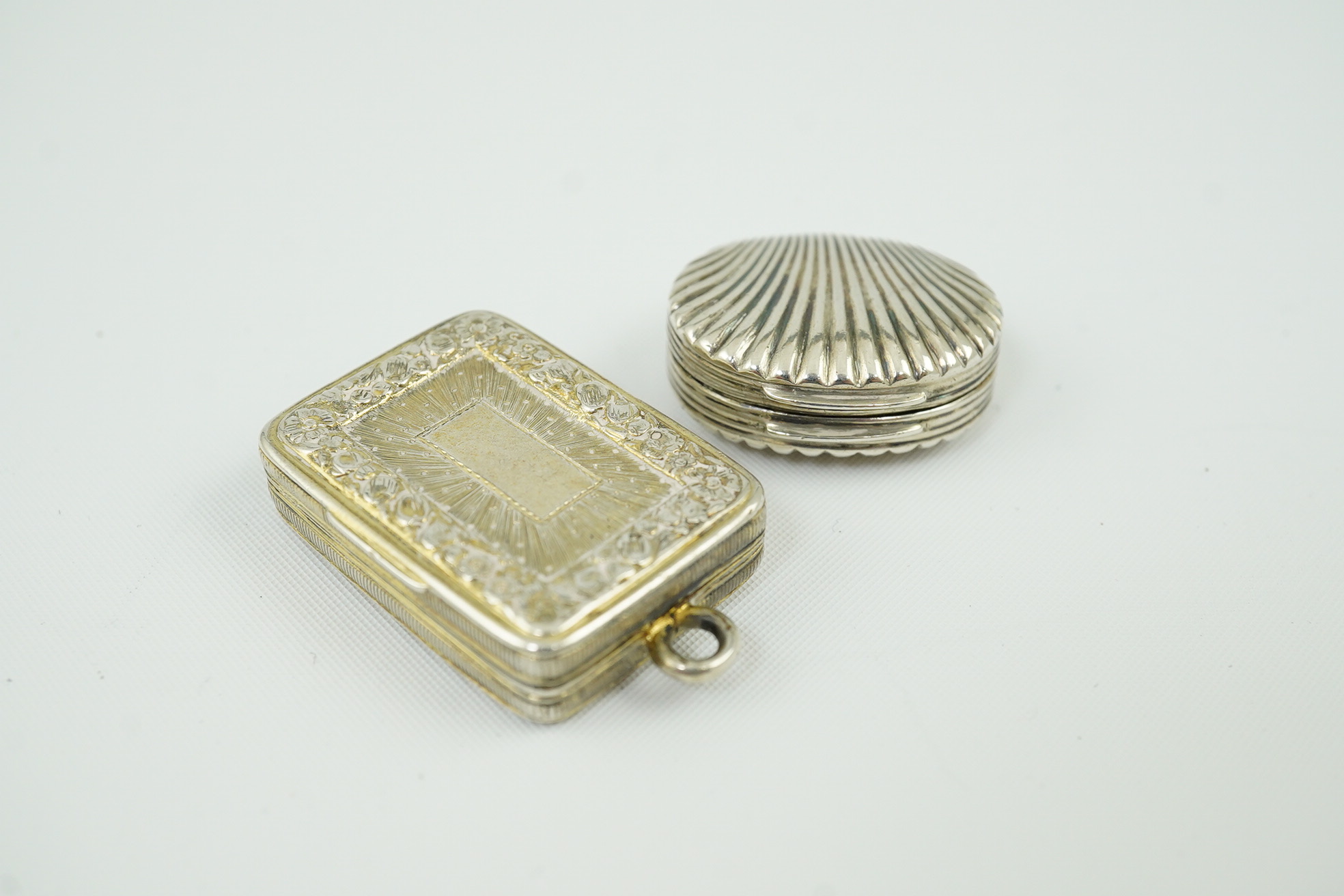 A late George III silver gilt vinaigrette by John Thropp, Birmingham, 1818, 30mm, together with a small shell shaped vinaigrette by Joseph Wilmore